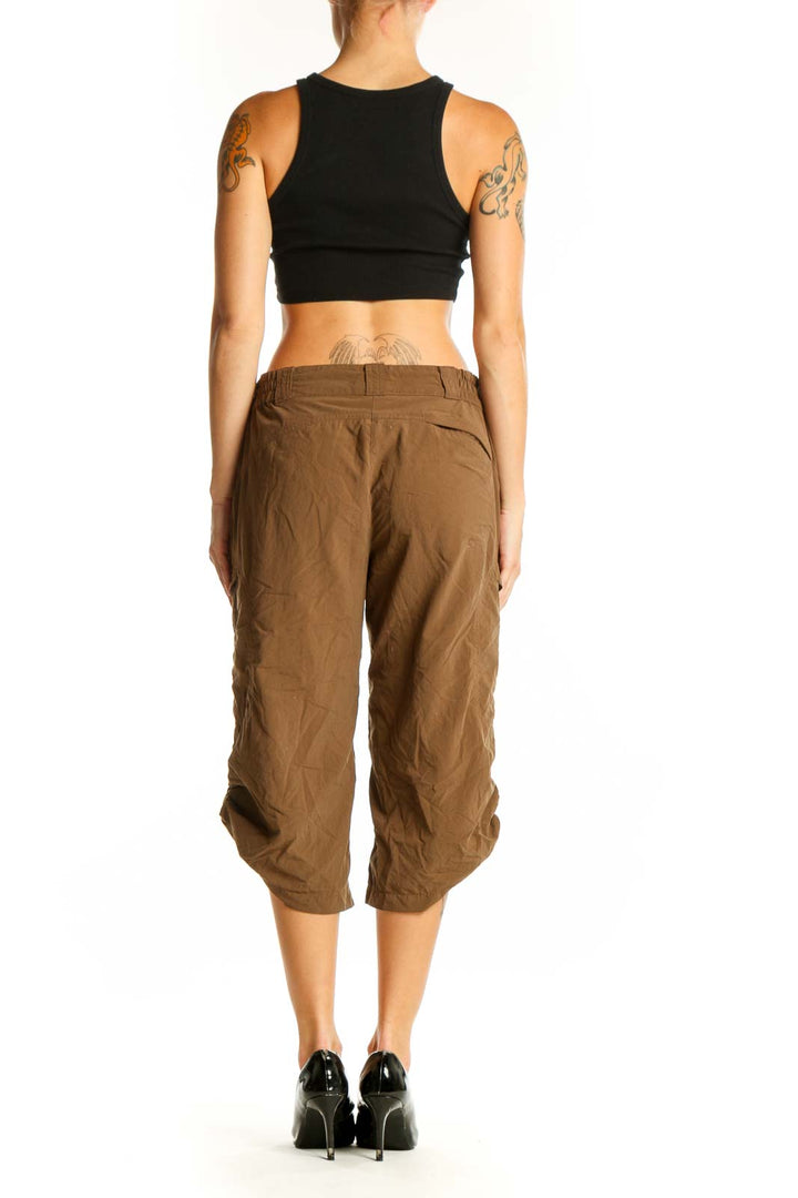 Side view of woman wearing brown nylon capri pants from Exofficio