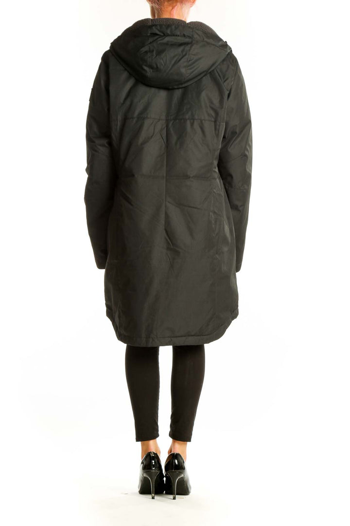 Side view of woman wearing dark green Columbia winter coat
