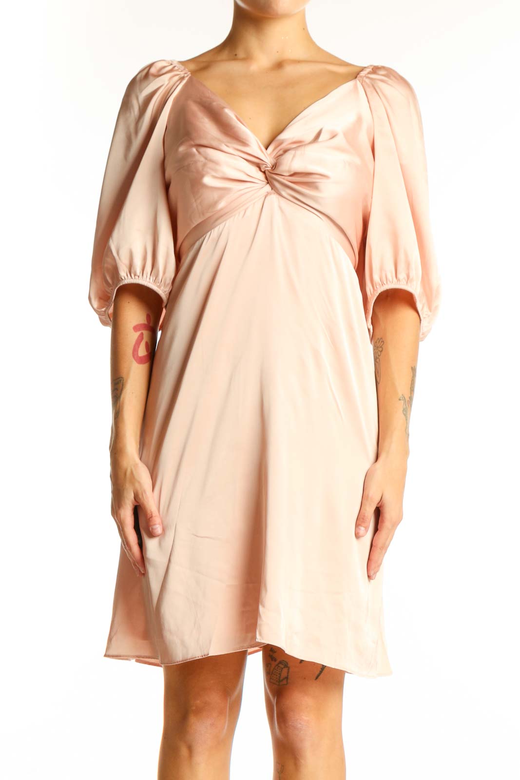 Front view of blush Express dress with twist-front detail and puff sleeves
