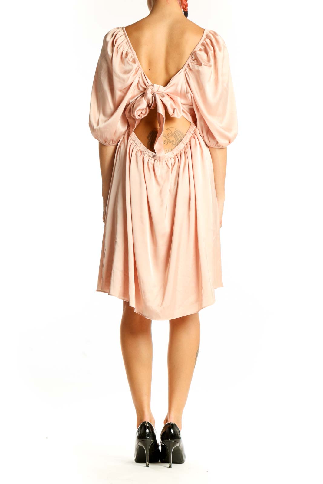 Side view of blush Express dress showing puff sleeves and flowy skirt