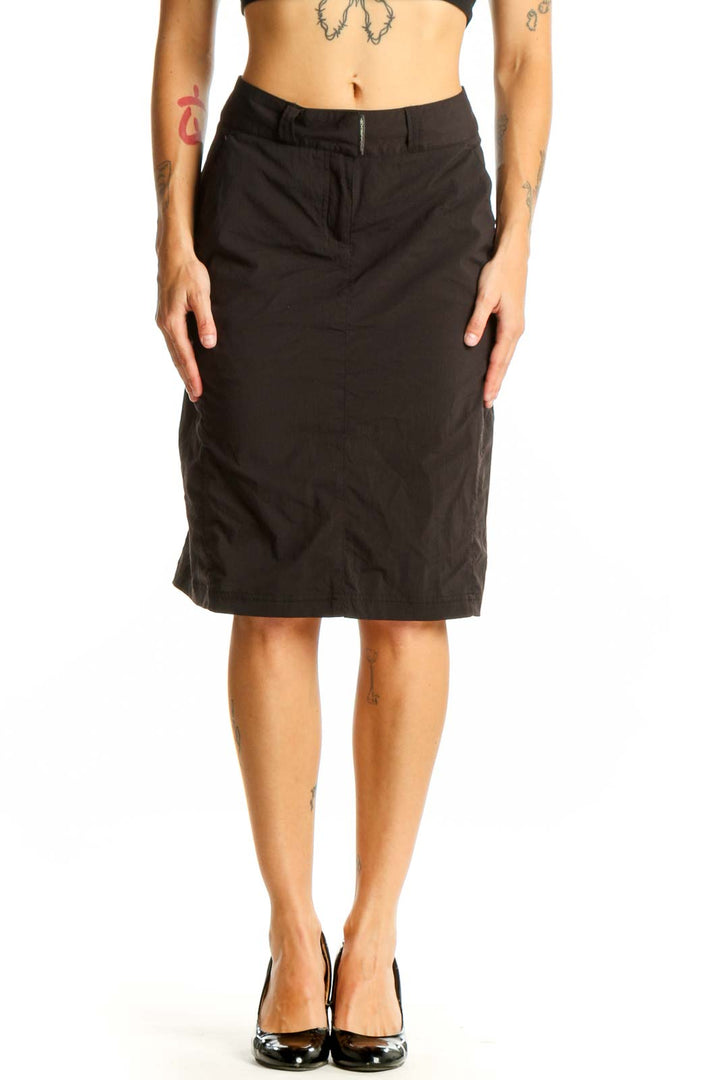 Front view of Exofficio black knee-length skirt on model