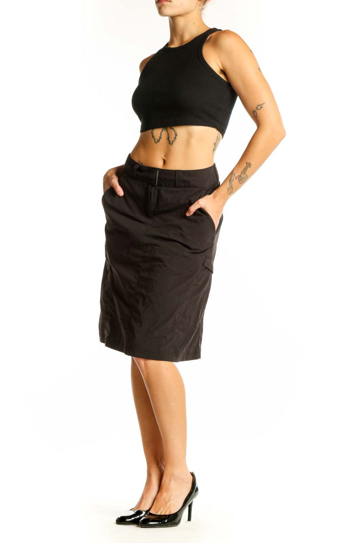 Front view of Exofficio black knee-length skirt on model