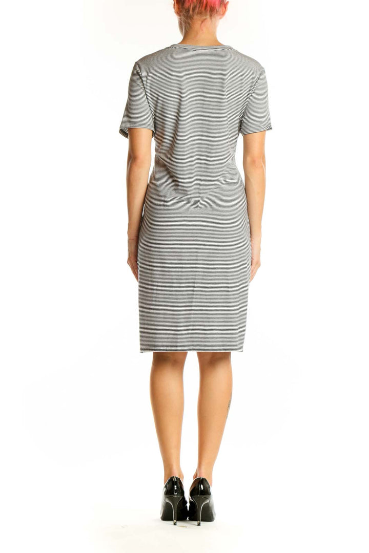 Side view of gray striped twist-front Theory dress showing waist detail