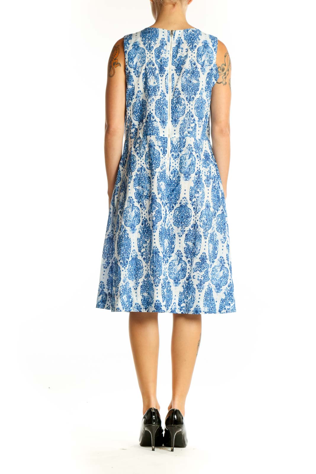 Side view of NYDJ blue and white floral print sleeveless dress showing A-line silhouette