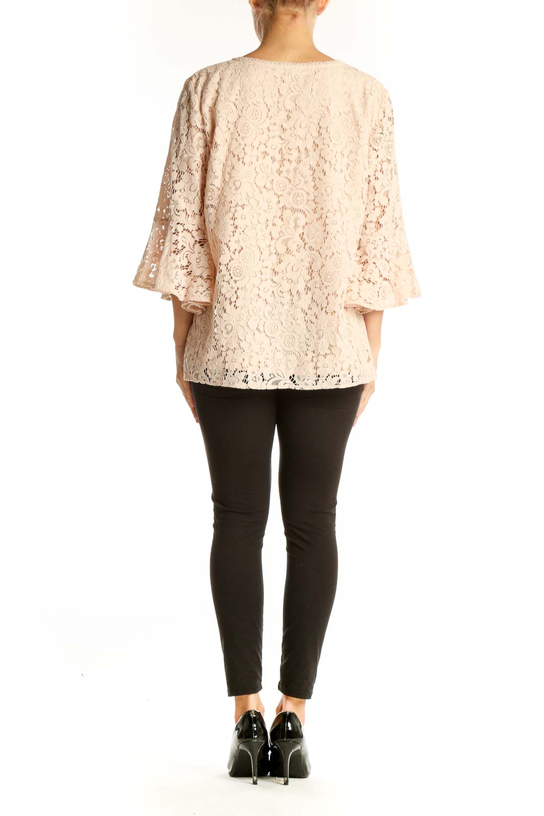 Side view of blush lace bell sleeve V-neck blouse from LOFT Outlet with black pants