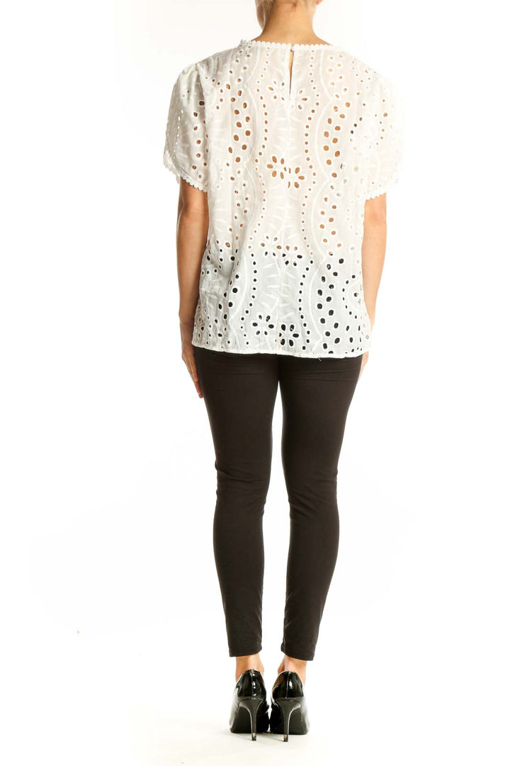 Side view of white eyelet lace short sleeve top by SilkRoll on model
