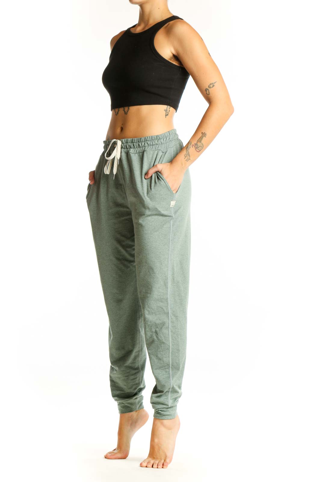 Front view of sage green Vuori jogger pants with drawstring waist