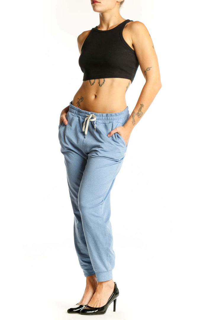 Front view of light blue Vuori jogger pants with drawstring waist
