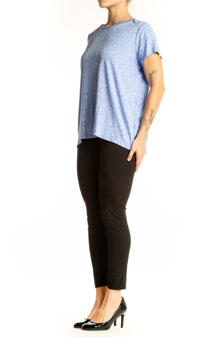 Front view of blue Marine Layer top with palm tree print