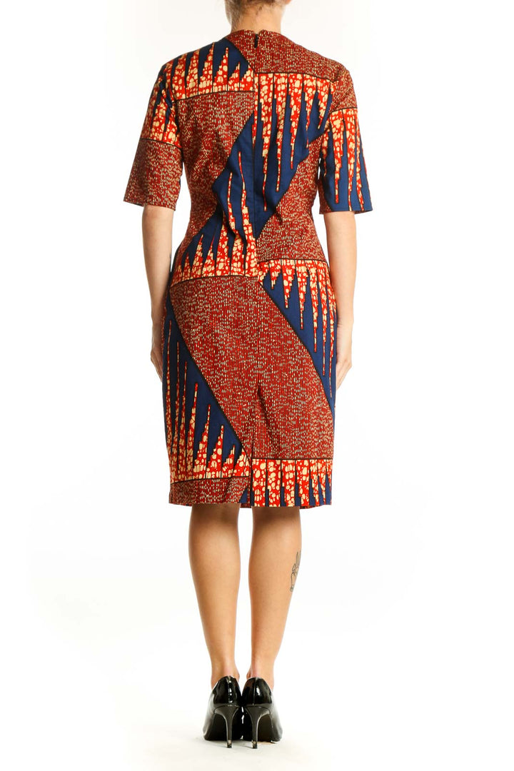 Back view of SilkRoll orange and navy geometric print midi dress