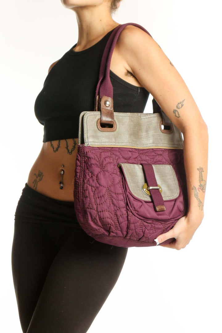 Front view of purple quilted Fossil messenger bag with beige trim