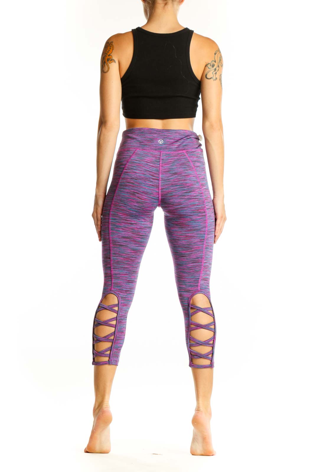 Side view of purple space-dyed Vogo capri leggings showing cutout details