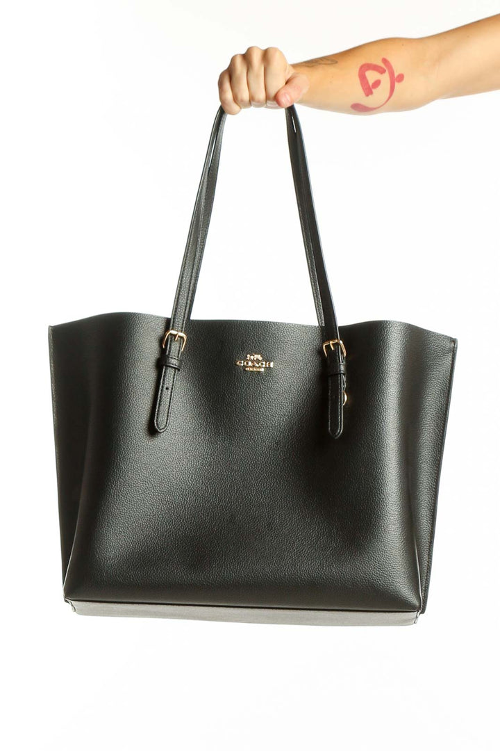 Front view of black leather Coach tote bag with gold hardware