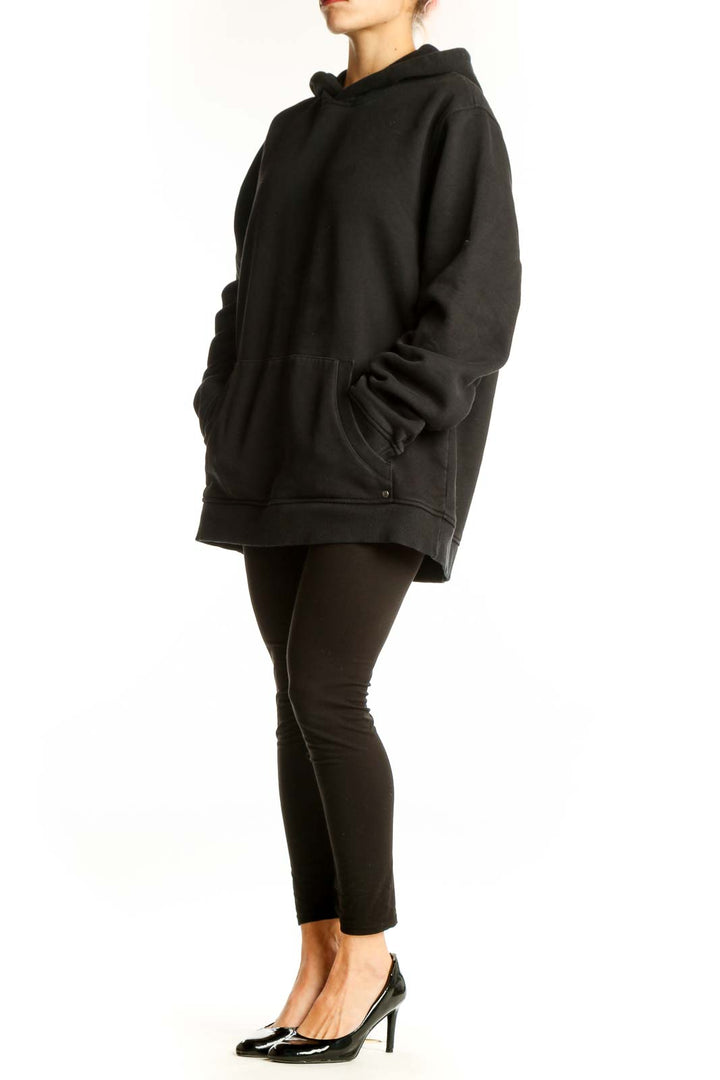 Front view of black Vuori oversized hoodie with kangaroo pocket