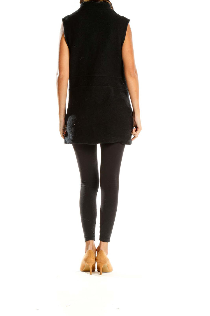 Side view of Icelandic Design black vest showing length and fit