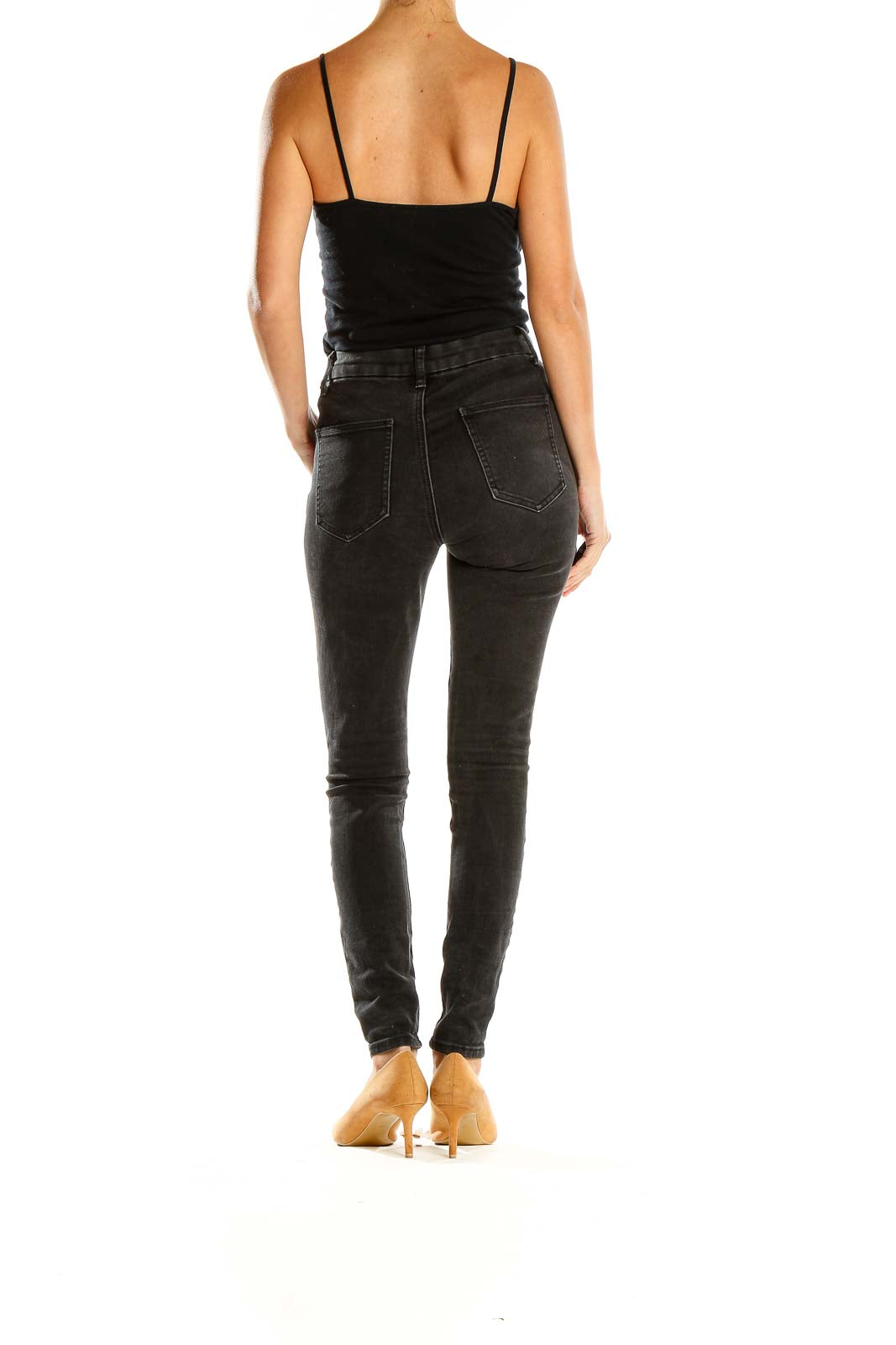 Side view of ASOS Denim black high-waisted skinny jeans on model