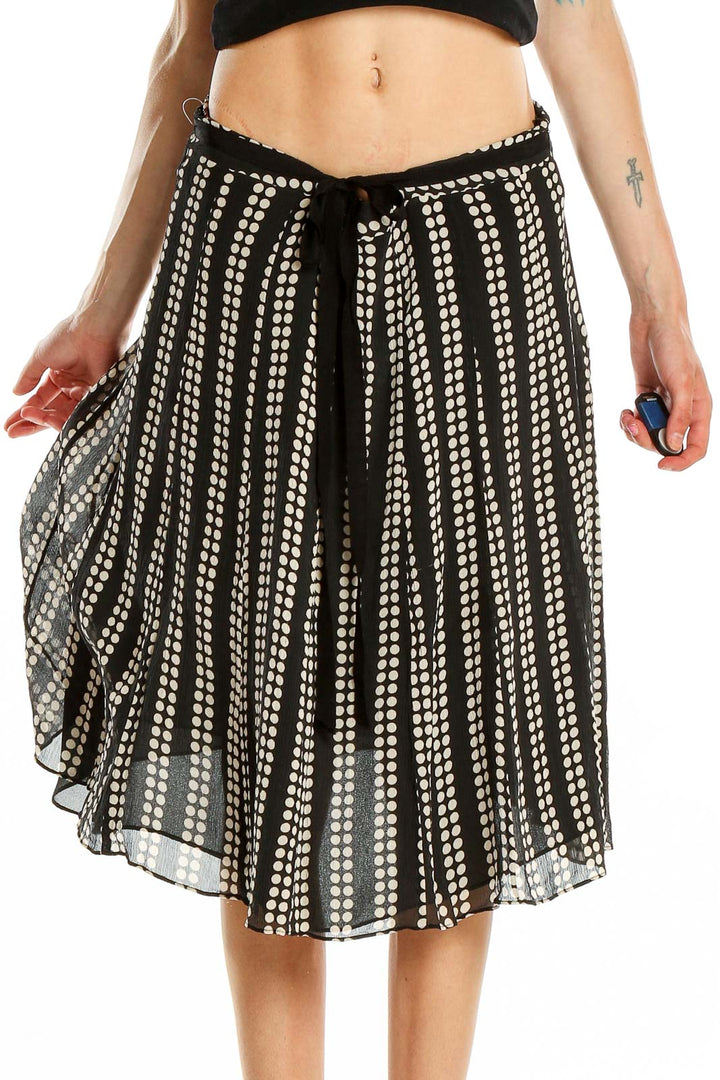 Front view of black and white polka dot pleated midi skirt by Uniform / John Paul Richard