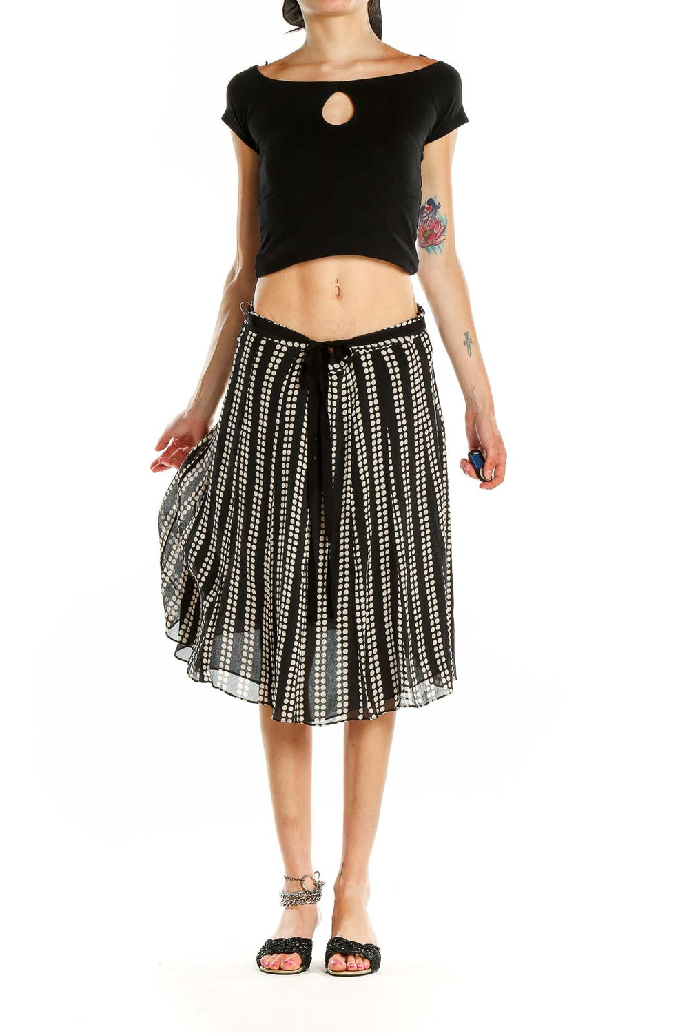 Front view of black and white polka dot pleated midi skirt by Uniform / John Paul Richard