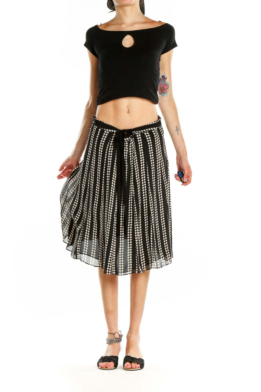 Front view of black and white polka dot pleated midi skirt by Uniform / John Paul Richard