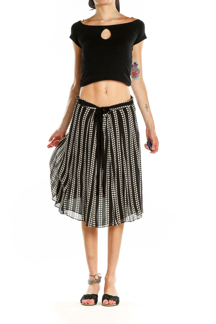 Front view of black and white polka dot pleated midi skirt by Uniform / John Paul Richard