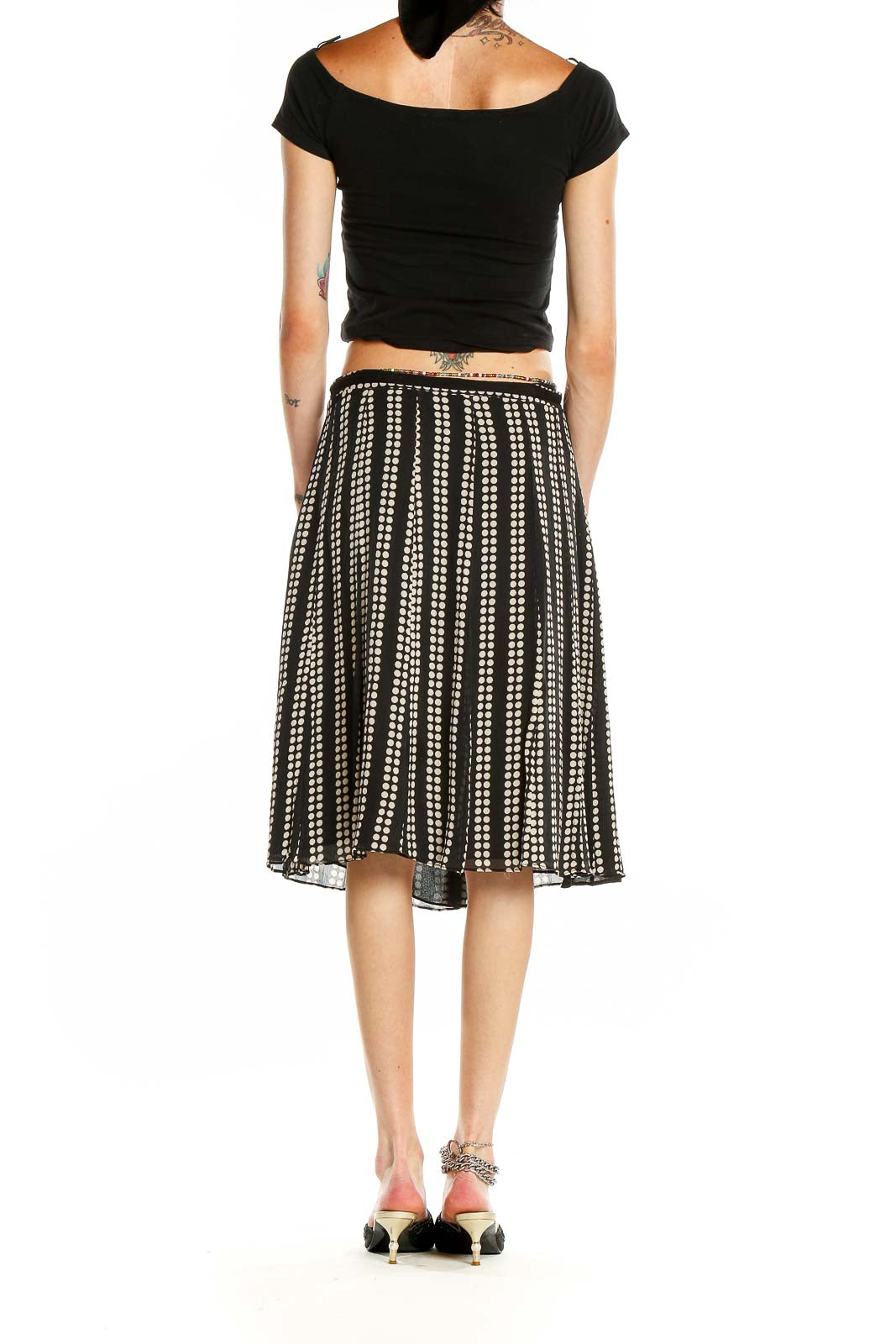 Side view of black and white polka dot pleated midi skirt by Uniform / John Paul Richard