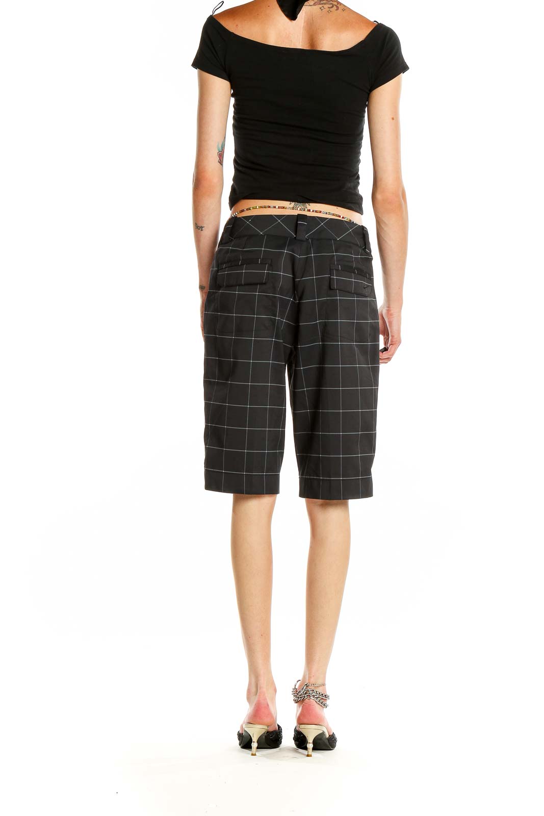 Side view of Nike Golf black plaid shorts on model