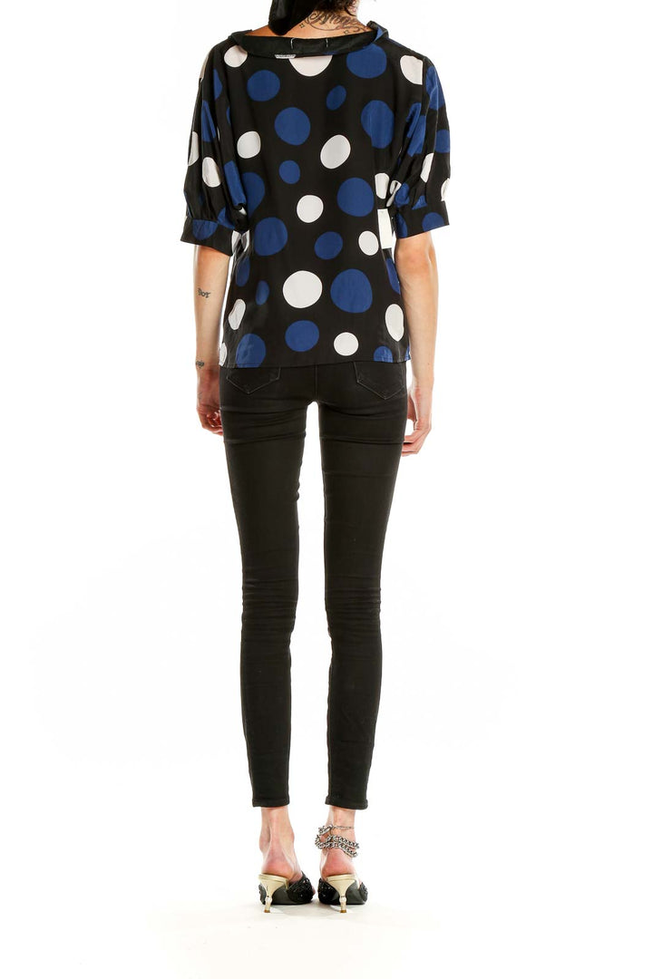 Side view of MICHAEL Michael Kors black polka dot blouse on model
