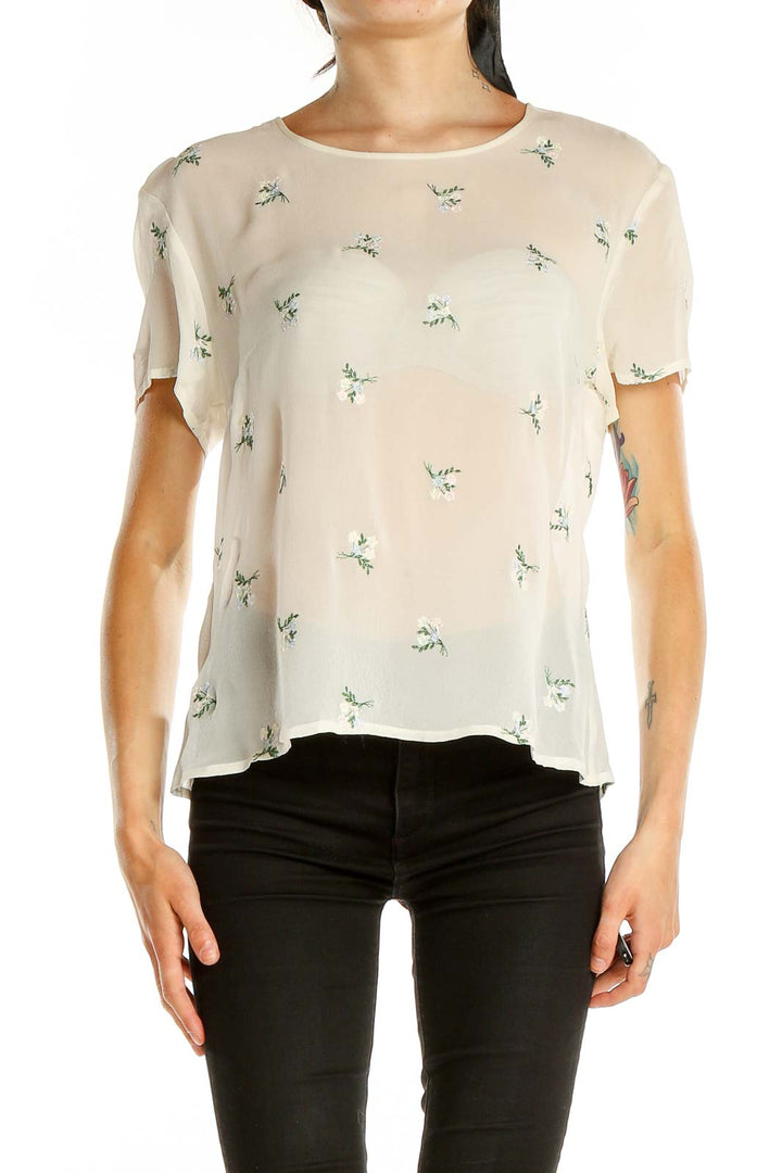 Front view of Laura Ashley cream blouse with green floral print and short sleeves