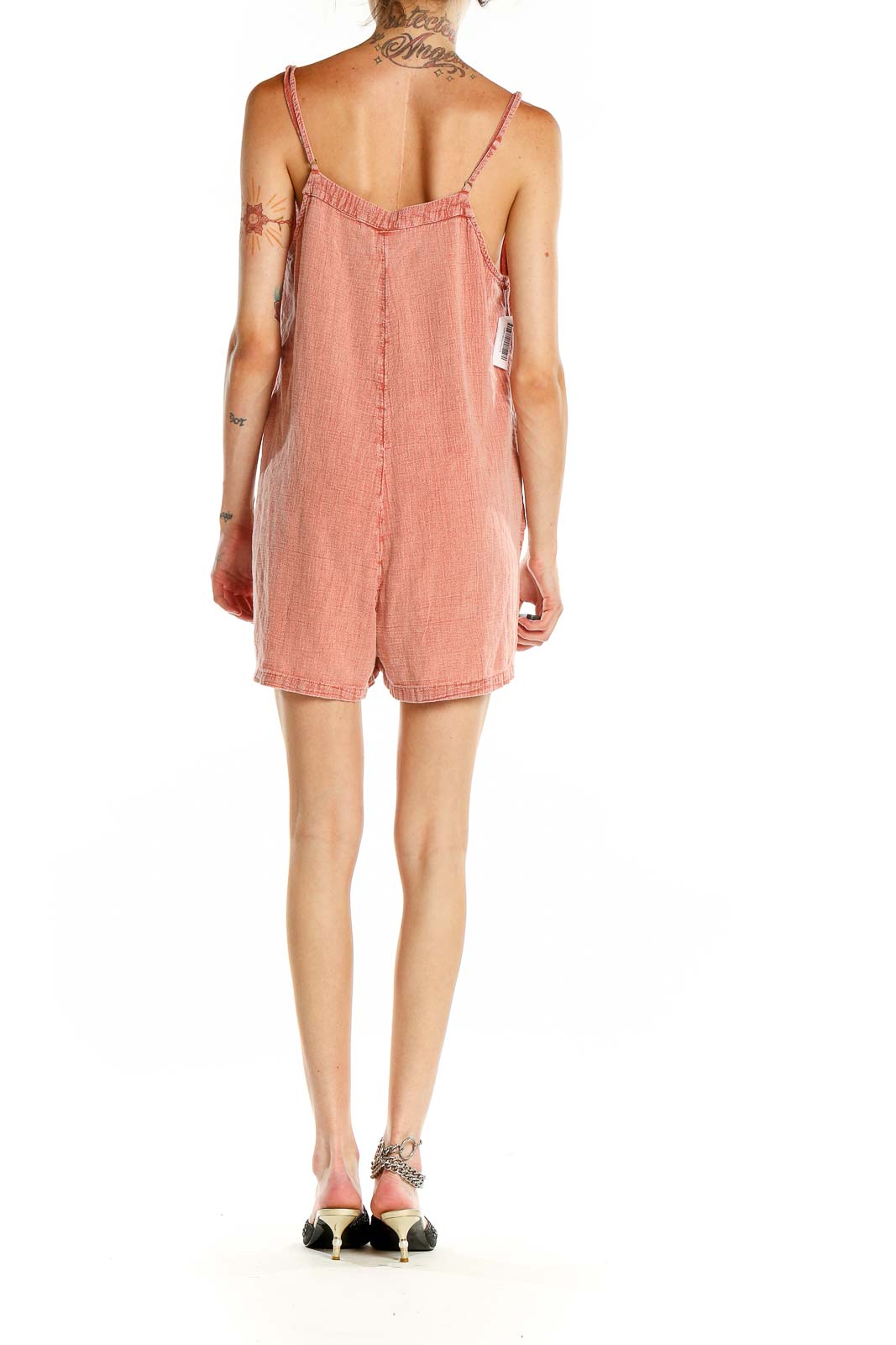 Side view of coral Ripcurl romper showing flowy silhouette