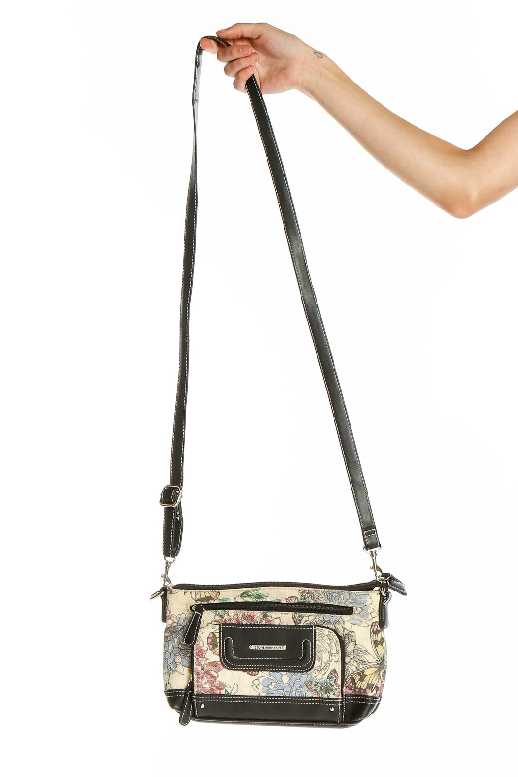 Front view of Stone Mountain floral print crossbody bag with black trim
