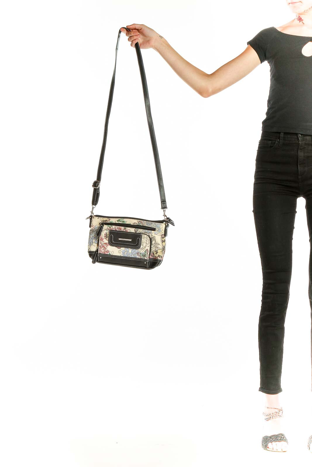 Front view of Stone Mountain floral print crossbody bag with black trim