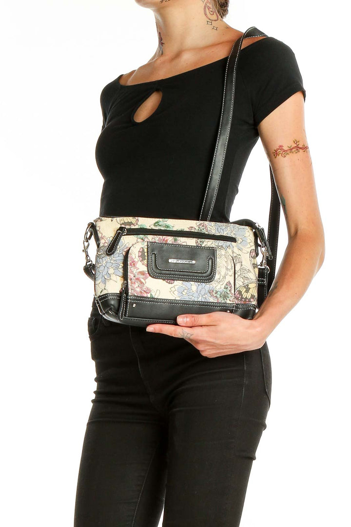 Front view of Stone Mountain floral print crossbody bag with black trim