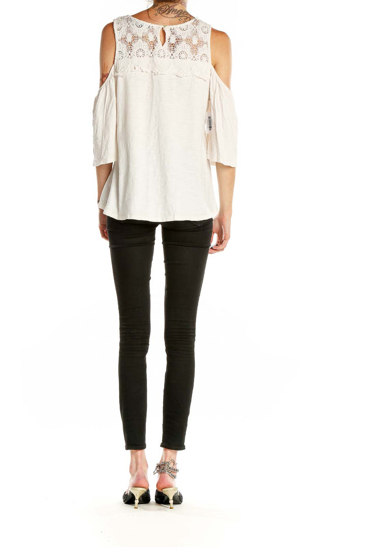 Side view of Sanctuary white lace cold shoulder blouse showing relaxed fit