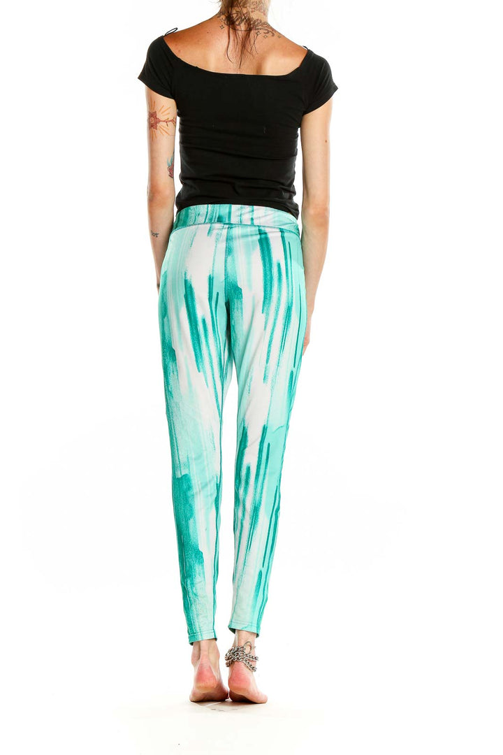 Side view of teal tie-dye Under Armour athletic leggings with black top