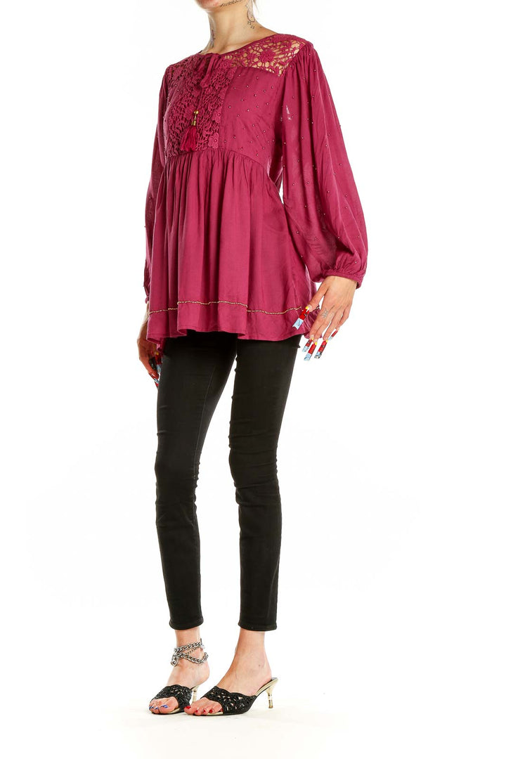 Front view of burgundy Free People tunic top with lace yoke and balloon sleeves