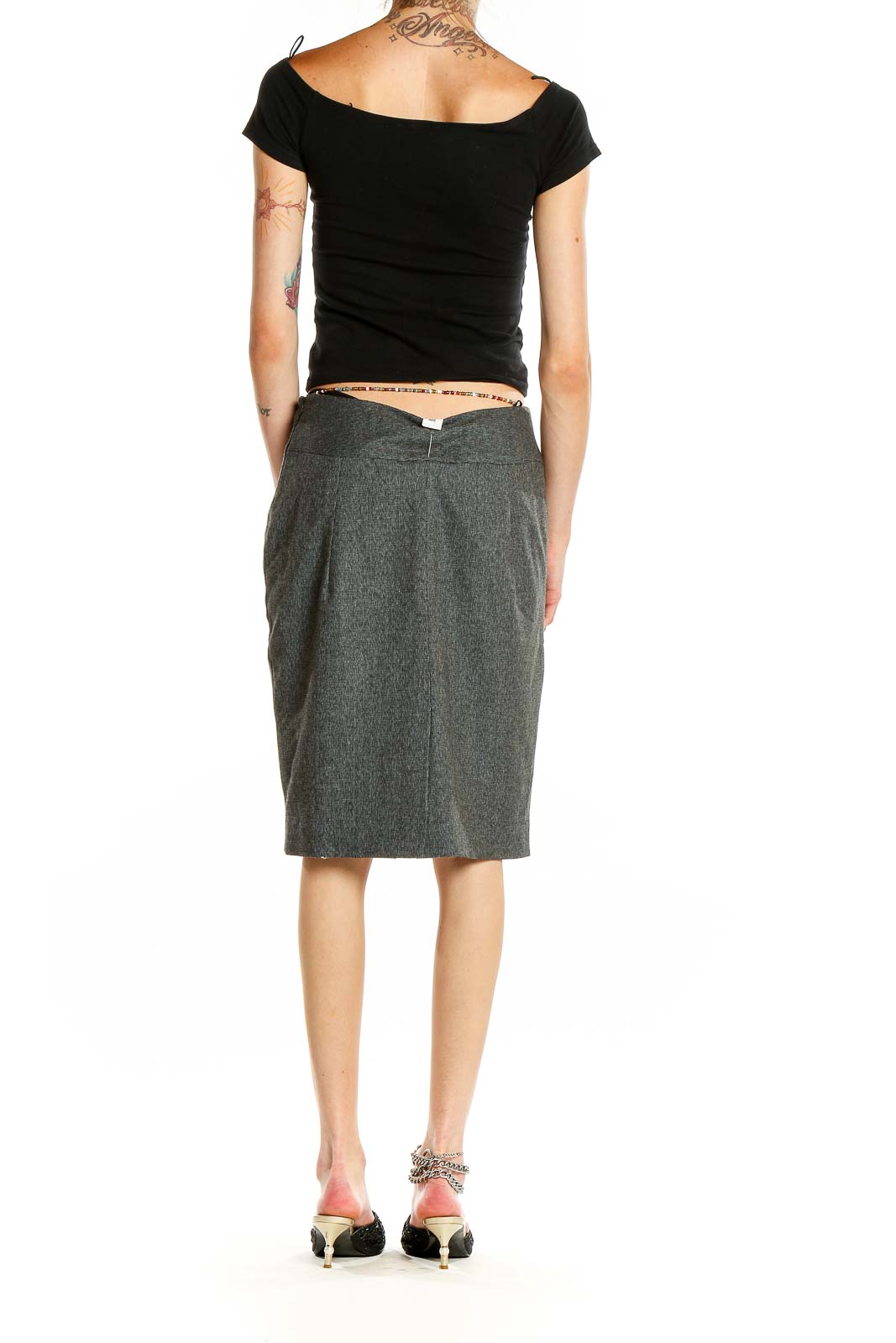 Side view of model wearing Anne Klein gray double-breasted pencil skirt with black top