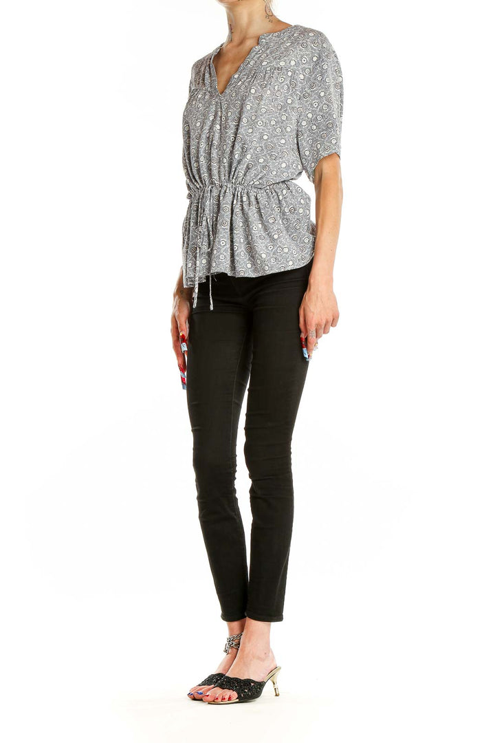 Front view of Treasure & Bond gray floral print peplum top with V-neck and short sleeves