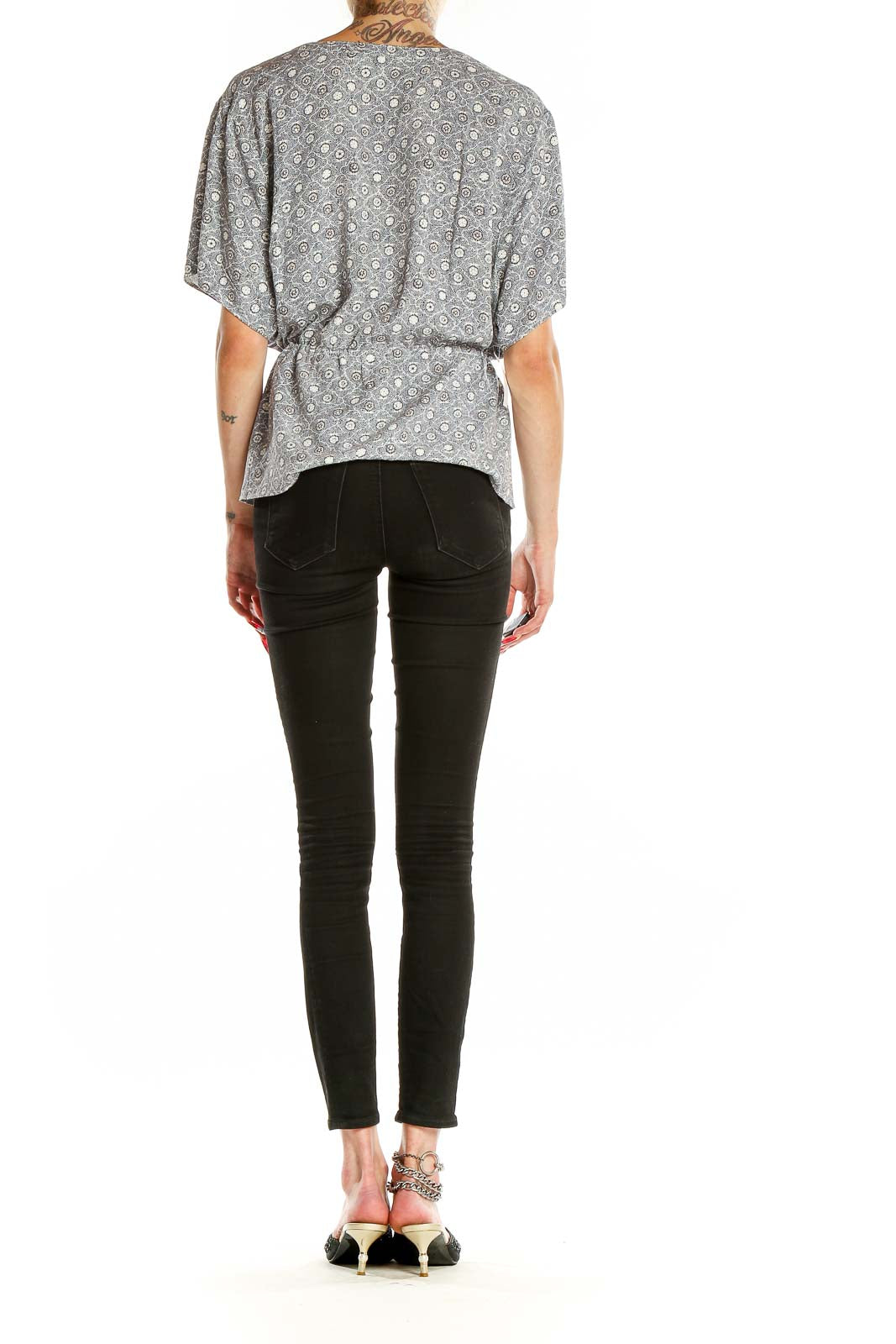 Back view of Treasure & Bond gray floral print peplum top showing gathered waist and peplum hem