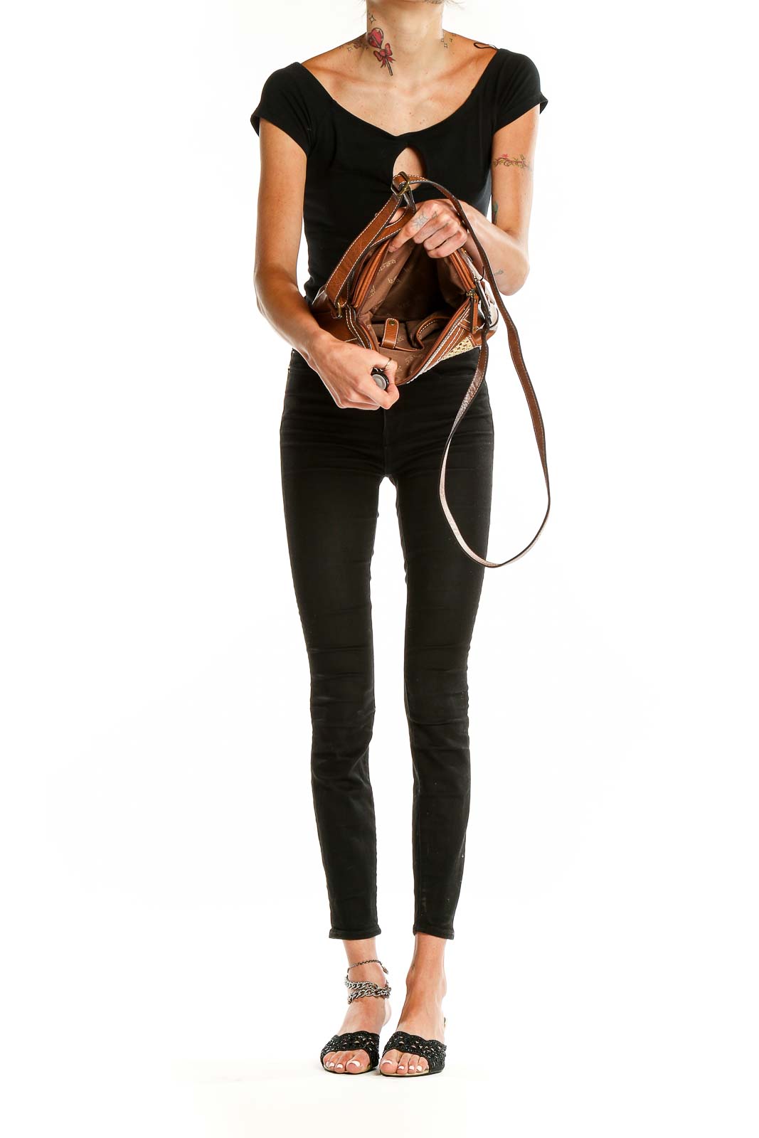 Model wearing Born Concepts brown crossbody shoulder bag with black outfit