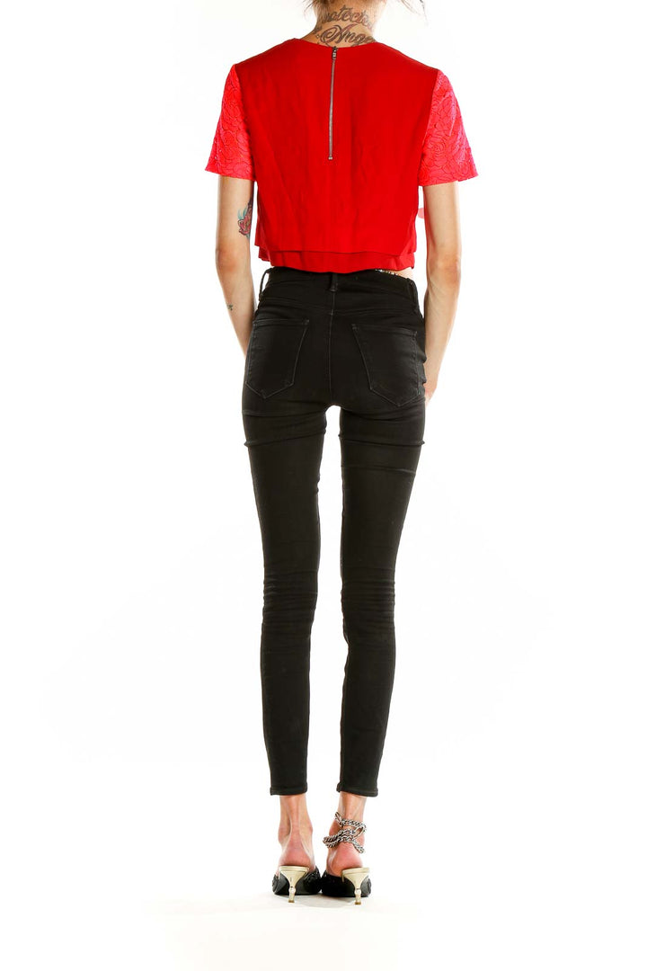 Back view of A.L.C. red floral lace crop top with zipper closure