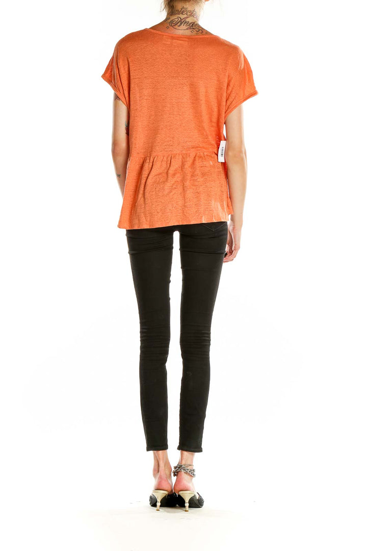 Back view of orange linen peplum top by Cynthia Rowley