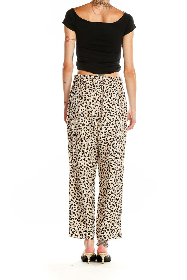 Back view of Ann Taylor beige leopard print wide-leg pants on model