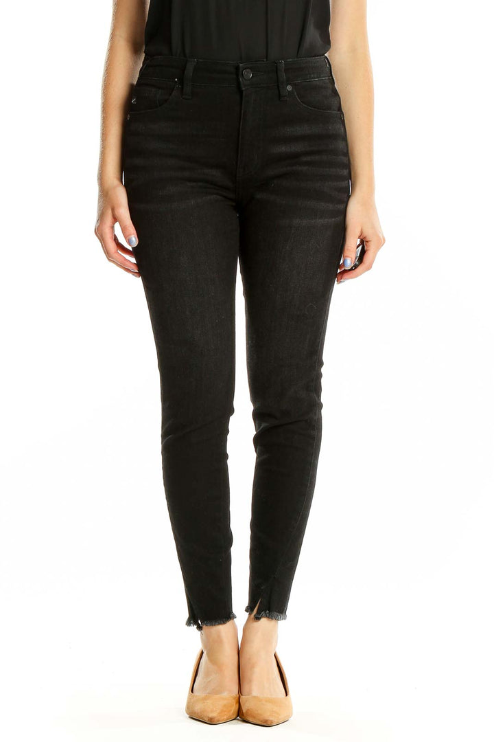 Front view of Kancan black high-waisted skinny jeans with raw hem