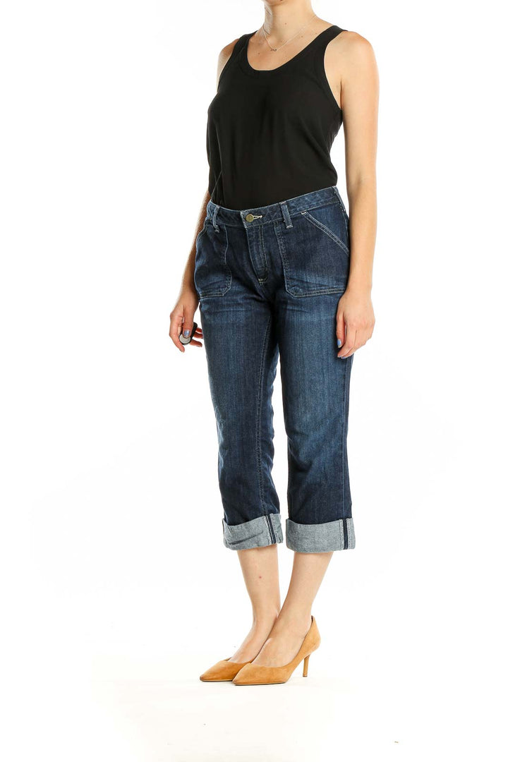 Front view of Carhartt dark blue cuffed capri jeans on model