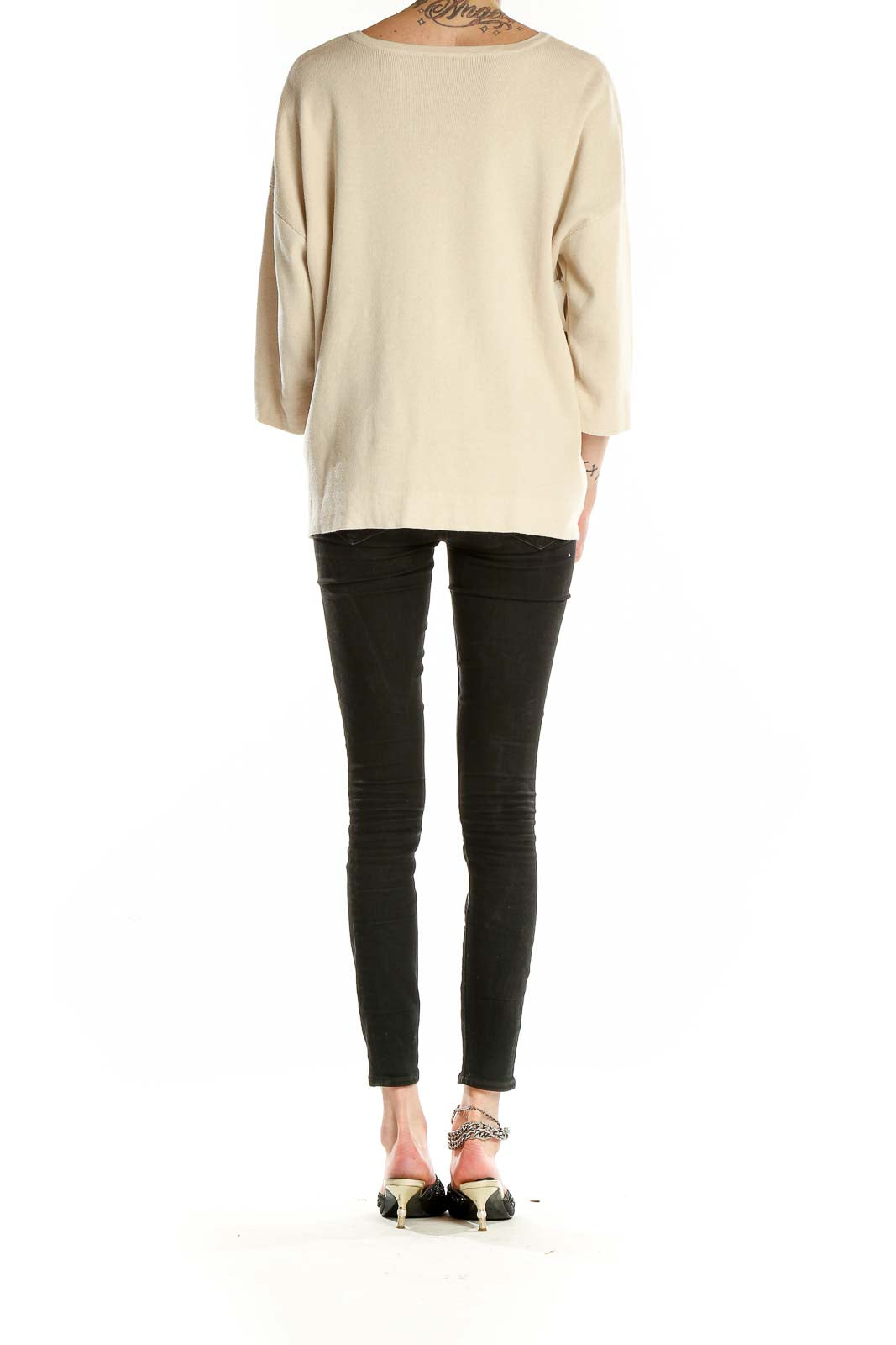 Back view of cream J.Jill relaxed fit knit sweater on model with black pants