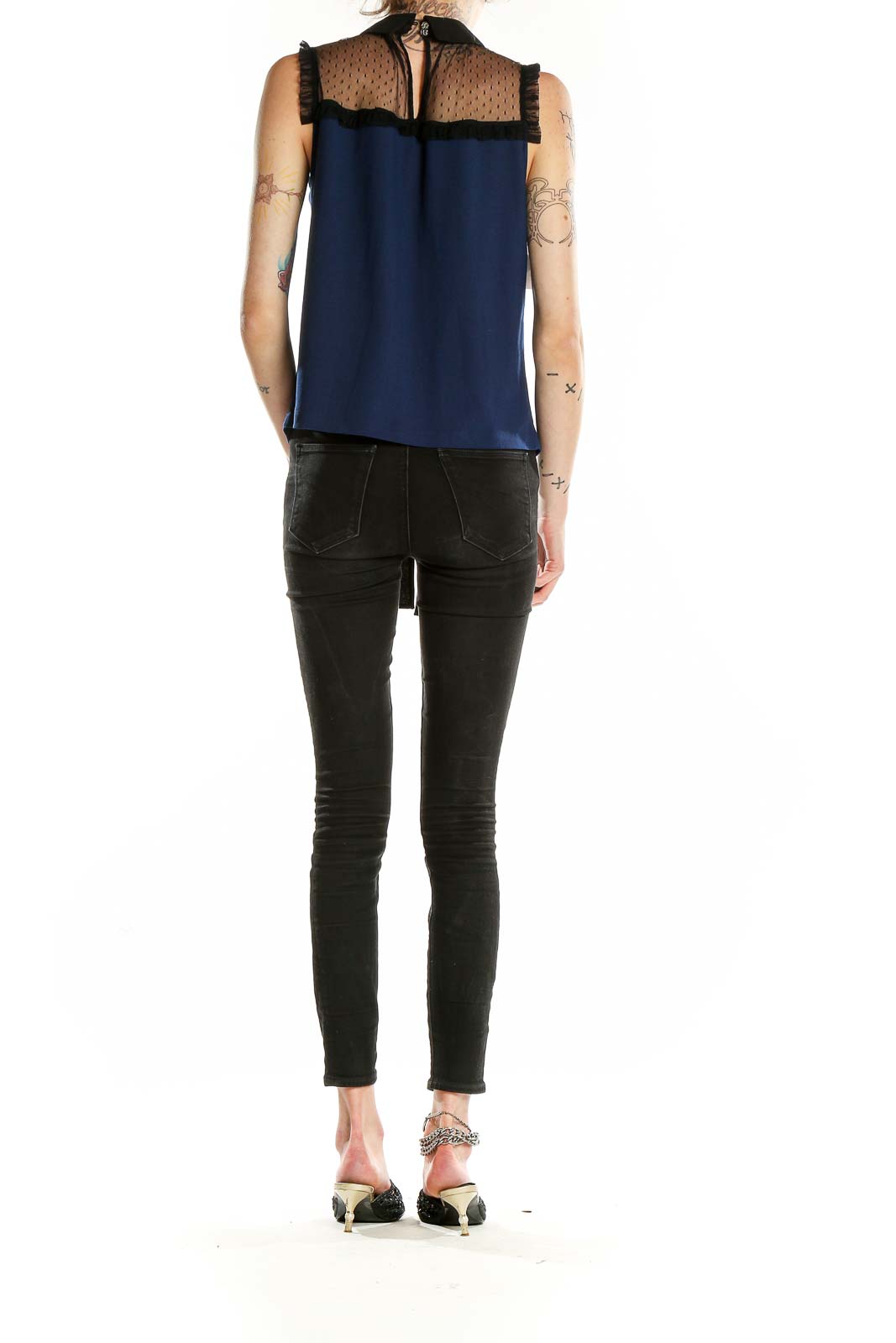 Back view of CeCe navy sleeveless blouse showing sheer lace upper back