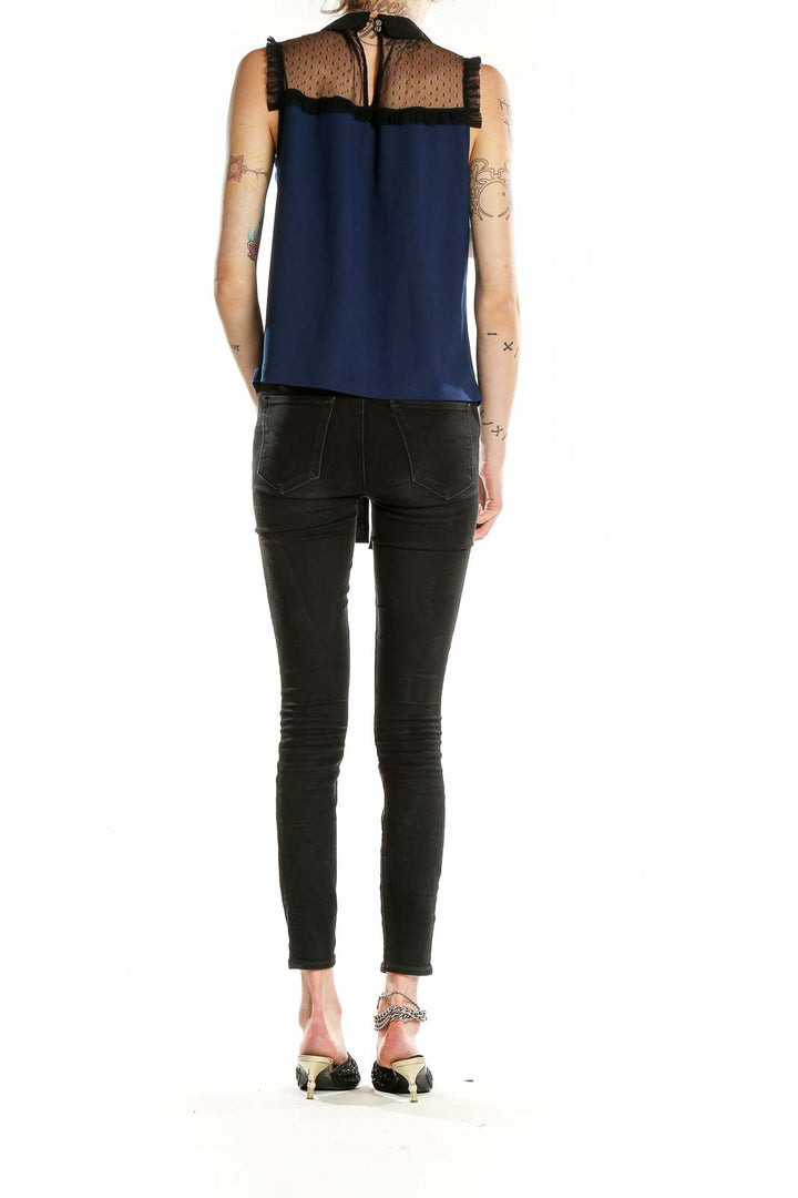 Back view of CeCe navy sleeveless blouse showing sheer lace upper back