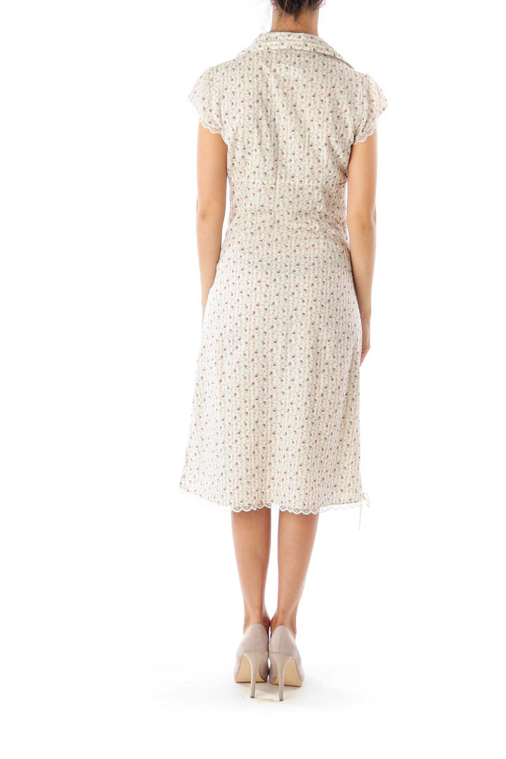 Back view of cream floral print midi dress from Free People showing button-up detail and A-line silhouette