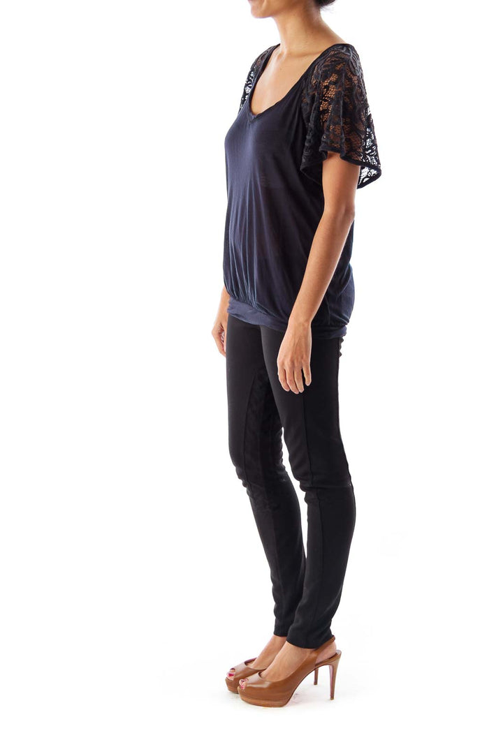 Front view of Free People black top with lace sleeves and scoop neckline