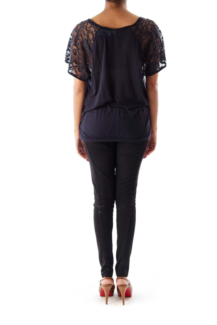 Back view of Free People black top showing lace sleeve detail and relaxed fit